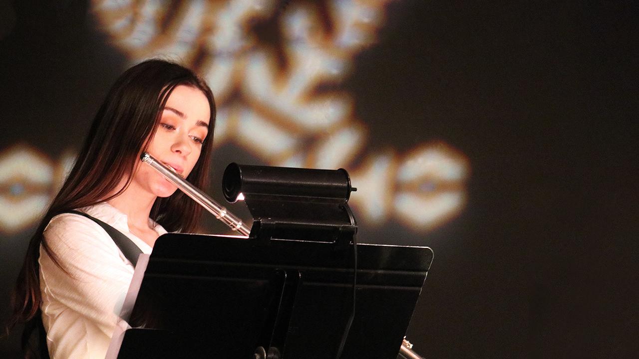 Student playing flute in Chase Collegiate Academy program